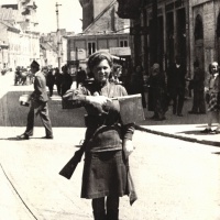 Príslušníčka sovietskej Červenej armády riadi dopravu na križovatke na Kamennom námestí v Bratislave. Apríl 1945